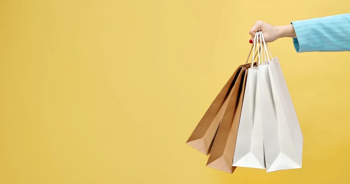 A person holding four shopping bags
