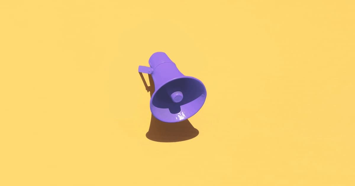 Purple megaphone on a yellow wall